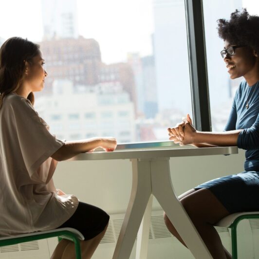 two-people-talking-at-table